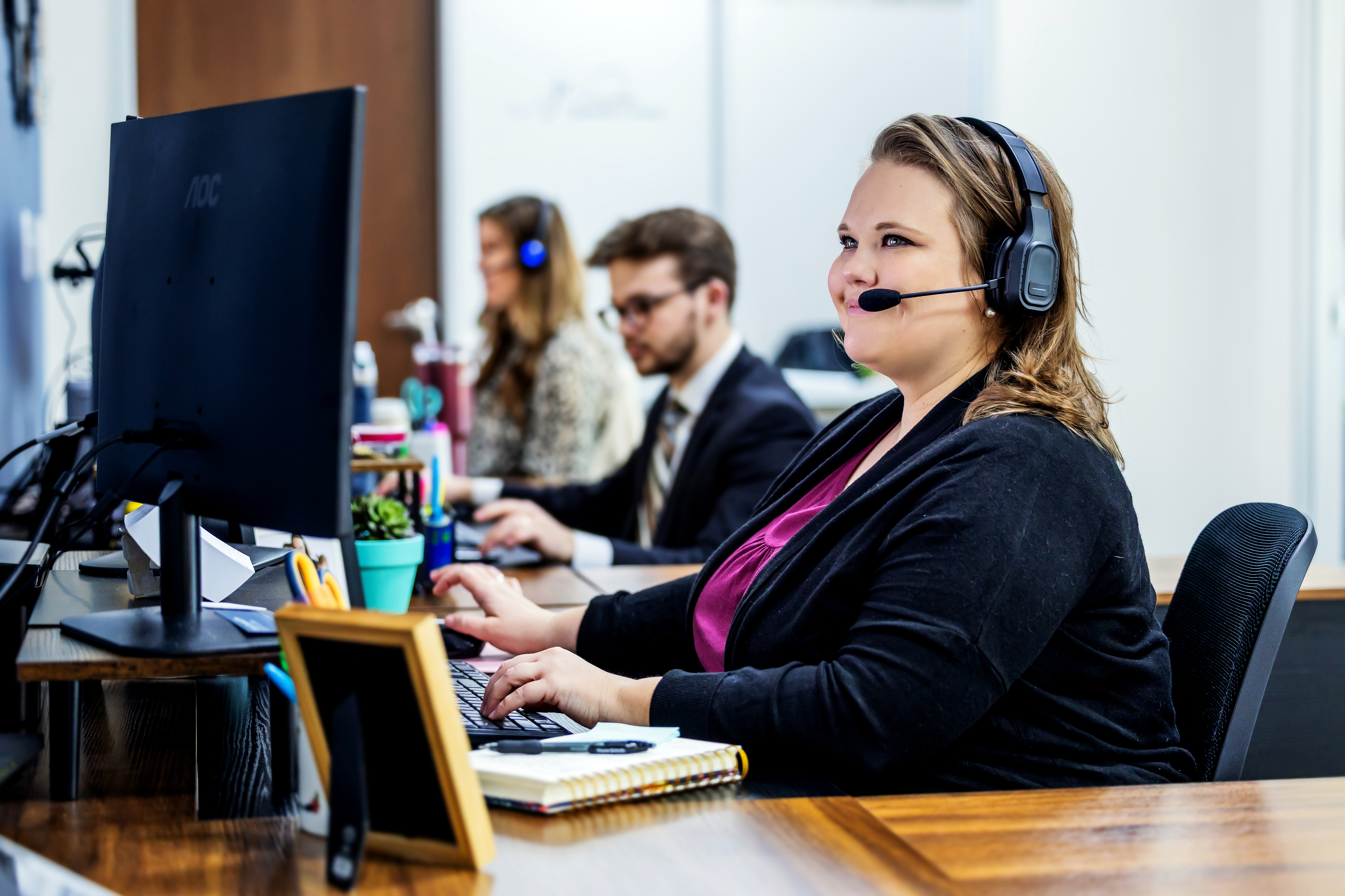 woman at computer on headset